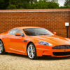 A collection of eight orange Aston Martins of different models will be put up for auction