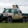 The classic Toyota Land Cruiser has been turned into a six-wheeled pickup truck with a machine gun